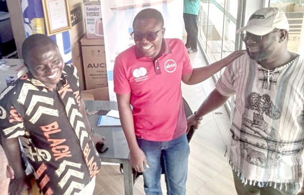 Innocent Kodzo Awumey (middle), Project Manager of AYAW, interacting with some of the beneficiaries