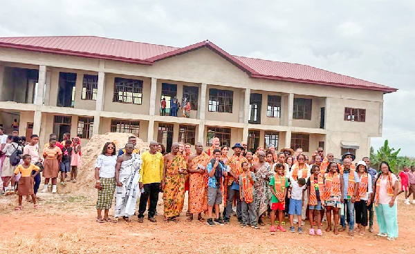 Justin Jones Fosu (arrowed) with members of the Work Meaningful Foundation, traditional leaders and teachers of Akyeremade DA JHS
