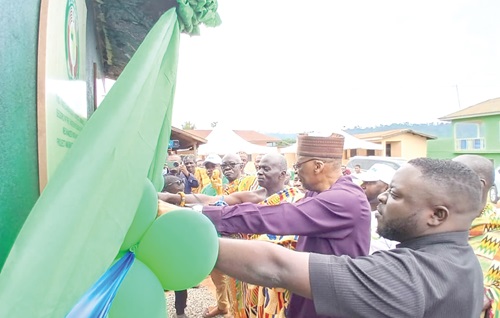  Baba Gana Wakil (right), Resident Representative of ECOWAS in Ghana, cutting the tape to officially inaugurate the new water facility at Odumase-Begoro