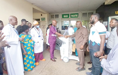 Michael Okyere Baafi (2nd from right), MP for New Juaben South, presenting a new mobile digital x-ray machine to Dr Arko Akoto-Ampaw (4th from left), Medical Director of the Eastern Regional Hospital