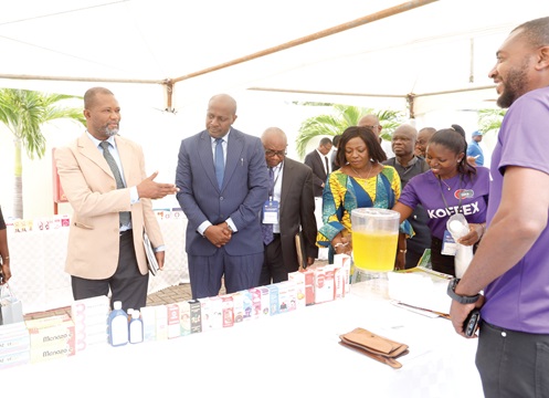 Dr Ignatius Awinibuno (left), Director of Allied Health, Ministry of Health, in a discussion with an official of Dannex Ayrton Starwin PLC during an exhibition. With him are other dignitaries. Picture: EDNA SALVO-KOTEY 
