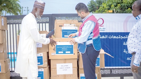 Admiral Tahiru (left) of the Islamic Education Unit and Hassan Owda, Director of Qatar Charity, inspecting the books