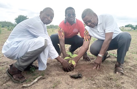  Sir Knight Brother Richard Ayih-Akakpo (right), President of MAREDES; Worthy Brother Maurice Adu-Amankwah (middle), Supreme Secretary of the Knights and Marshall; being supported by Rev. Fr James Yamba, the Chaplain and Chairman of the tree planting committee, to plant a tree