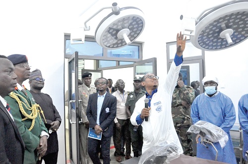 Dr Redeemer Seyram Fiebor, Head of HTU Clinic, conducting Major General Yusuf (2nd from left), Professor Ben Q. Honyenuga (left), Vice-Chancellor of HTU, and some guests and officials of the university round the theatre