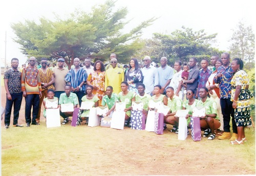 Sampson Adjei (7th from right standing) with staff and some old students as well as the beneficiaries (squatting) after the presentationSampson Adjei (7th from right standing) with staff and some old students as well as the beneficiaries (squatting) after the presentation