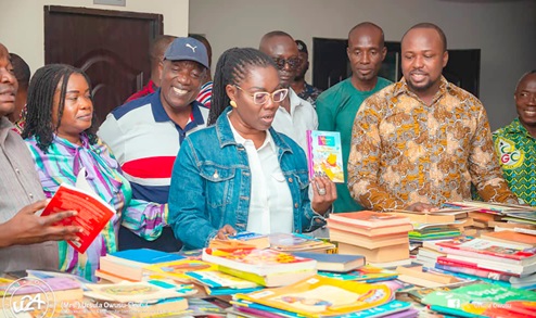 Ursula Owusu-Ekuful (middle), Minister of Communications and Digitalisation, and Evans Koletey Tene (2nd from right), Eastern Regional Director of the Ghana Library Authority, during presentation of the books