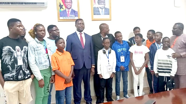 Dr Yaw Adutwum (4th from left), Minister of Education, with Francis Okyeahene (5th from left), Director of Young Executive and Onua Francis schools, and students  