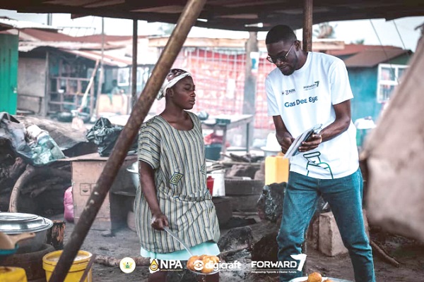 Johnson Gbagbo Jnr (right), Supervisor, NPA Gas Directorate, engaging a trader at the Anhwia Nkwanta market