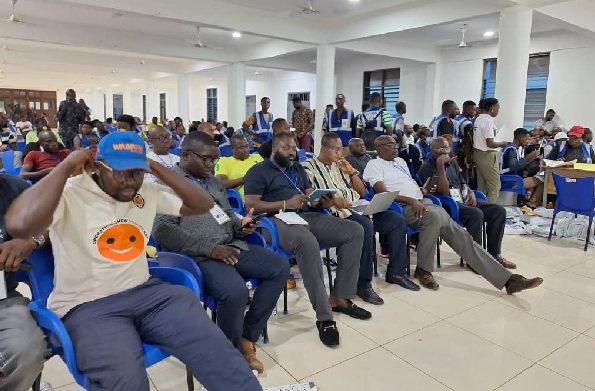 Adamu Ramadan (3rd from right) seated and waiting for the collation