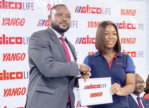 Tom Ofonime (left), exchanging the signed partnership deal with Maame Dufie Achampong-Kyei