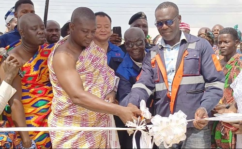 Nana Atta Kakra IX (2nd from left) assisting Jhorge Sam, Director, Executive Quarry Limited, to inaugurate the community centre