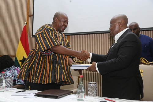 President Akufo-Addo presenting documents to John Dramani Mahama (in smock), President-elect, during the inauguration ceremony at the Accra International Conference Centre. Picture: SAMUEL TEI ADANO