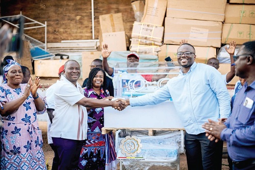 Dr Felix Asiedu (right) thanking Alexander Akwasi Acquah, MP for Akyem Oda, for the donation. With them is Joyce Adjoa Agyeiwaa (middle), the Municipal Chief Executive for Birim Central.