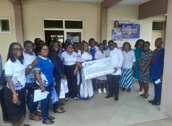 Rev. Rita Korankye Ankrah, President General of Royal Ladies Ministries presenting the check to leaders of the hospital