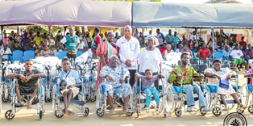 Samuel Okudzeto Ablakwa (arrowed) with some of the beneficiaries after presenting the wheelchairs to them