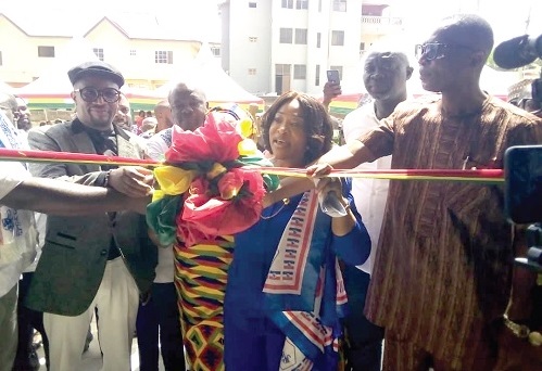 Shirley Ayorkor Botchwey (middle), the Minister of Foreign Affairs and Regional Integration, being assisted by other dignitaries to cut the ribbon to inaugurate the water factory (inset)