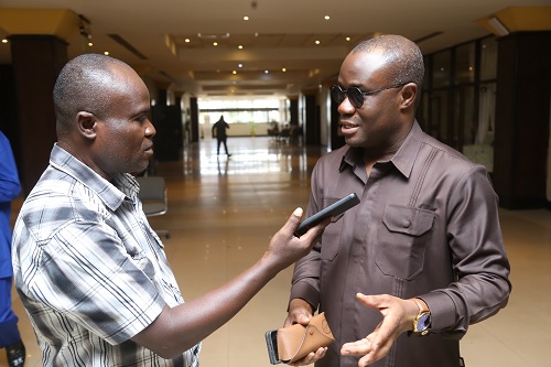 Emmanuel Bonney (left), a Staff Writer, Daily Graphic, interviewing Felix Kwakye Ofosu, Spokesperson of the Transition Team, NDC, at AICC.  Picture: SAMUEL TEI ADANO
