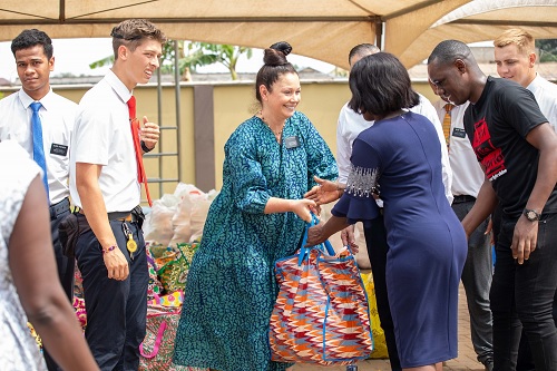 Some members of the Church of Jesus Chirst handing over the packs of essential food items to beneficiaries at Madina