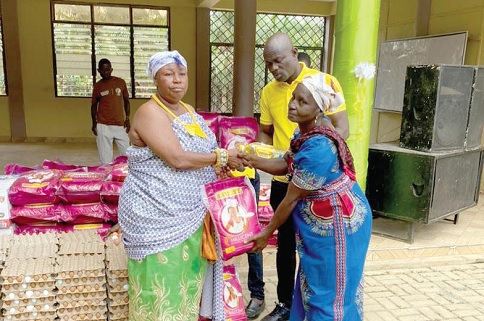 Nana Asantewaa Nkyemah (left) presenting some of the items to one of the beneficiaries 