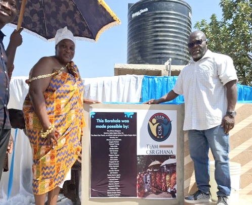 Nana Akosua Serwaa Seoyo l (left), the Queenmother of Ahenmronomu, and Jonathan Akuamoah, the Chief Executive Officer of TEAM CSR, after inauguration of the borehole (in the background)