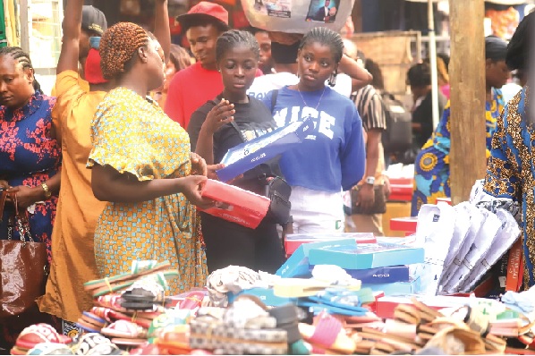 Some residents of Kumasi buying slippers at Adum in Kumasi