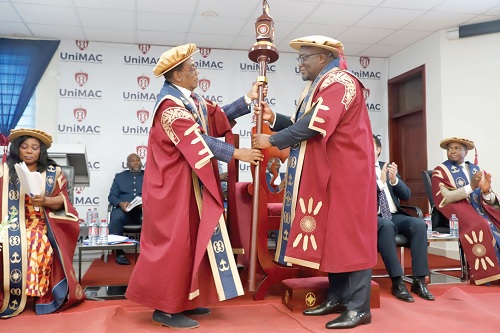 Prof. Kwesi Yankah (left), Chairman of Council, UniMAC, presenting the Mace, a symbol of office, to Prof. Eric Opoku Mensah, Vice-Chancellor of UniMAC. Picture: EDNA SALVO KOTEY