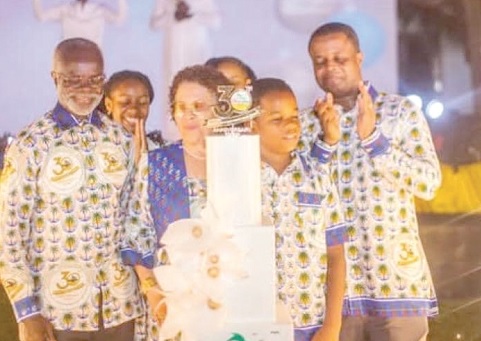 Dr Paa Kwesi Nduom (left) and family cut the anniversary cake to mark the event 