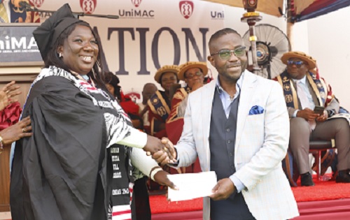 Charles Benoni-Okine (right), Assistant Editor, Graphic Business, presenting the Best Graduating Student in Print Journalism (Regular Programme) Award to Annan Kezia Naa Kordei, at the ceremony. Picture: EDNA SALVO KOTEY