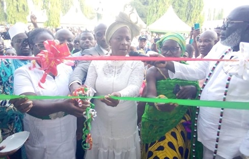 Comfort Doyoe Cudjoe, the Member of Parliament for Ada, being assisted by other dignitaries to cut the ribbon to inaugurate the facility