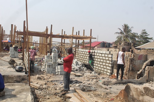 Carpenters and masons rebuilding the structures. Picture: ESTHER ADJORKOR ADJEI 
