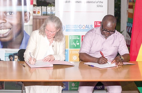 Marianne Thyrring (left), Director-General, Danish Meteorological Institute, signs for the institute, while Eric Asuman, acting Director-General, Ghana Meteorological Agency, appends his signature for the aggreement. Picture: Caleb Vanderpuye