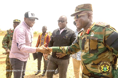 Saeed Muhazu Jibril (left), Savannah Regional Minister, in a handshake with Major General Dr Emmanuel Koti (right), National Coordinator, GhBC, during the visit to Dollar Power. With them is Samuel Abu Jinapor (2nd from right), Minister of Lands and Natural Resources, and other officials