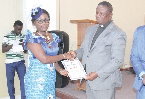 Dr Cyril G.K. Fayose, General Secretary, Christian Council of Ghana, presenting a certificate to Dr Juliana Maame-Esi Owusu-Ansah (left), a graduate of the Counselling school.  Picture: ERNEST KODZI
