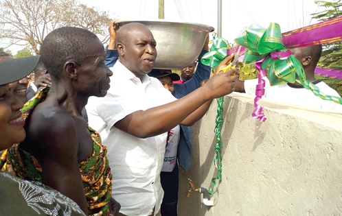 The Kokoa market facility. Inset: Frederick Yaw Ahenkwah, Member of Parliament for Jaman North, cutting the tape to inaugurate the Akroforo water system