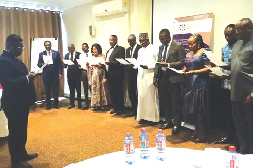 Dr Kofi Mbiah (left), a fellow of the Chartered Institute of Logistics and Transport, inducting the new members into office
