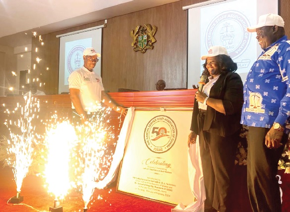 Samuel Afotey Otu (left), JUSAG President, unveiling the anniversary logo. Looking on is Gertrude Sackey Torkornoo, the Chief Justice, and Justice Gabriel Pwamang, a Justice of the Supreme Court.