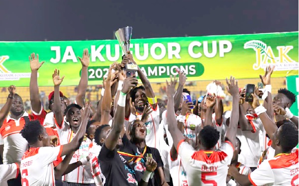 Kotoko captain Richmond Lamptey lifts the trophy as he celebrates the victory with his teammates 
