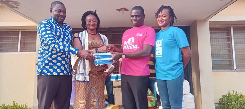 Gilbert Asante (2nd from right), Project Coordinator, WaterAid Ghana, presenting the items to Estella Abazesi (2nd from left), Director of Health Services, Bongo District, and Alhassan Lawal (left), Kassena Nankana West District Director of Health Services