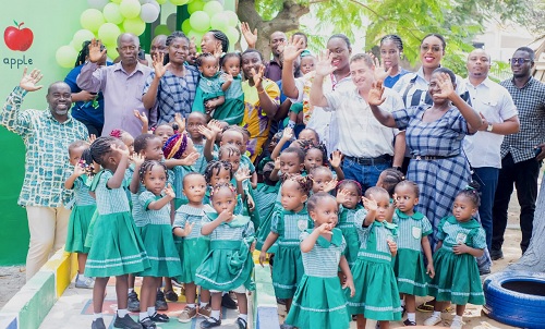 Some children and  staff of the school as well as the benefactors. INSET: The refurblished school