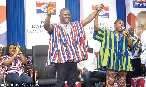 Essuman Barnes Solomon (right), West Gonja Municipal Electoral Officer,  lifting up Samuel Abu Jinapor's hand to officially confirm his candidature for the NPP Damongo ticket