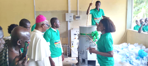 Vivian Ahiayibor (right), Managing Director of City Waste Recycling Limited, explaining the processes to Archbishop Emeritus of Cape Coast, most Rev. Mathias Kobena Nketsiah. With them is Rev. Fr Amoah Gyasi and other dignitaries after the inauguration of the plant