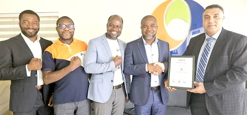 Wael Salah (right) presenting one of the certificates to Michael Bozumbil, CEO of PETROSOL, being supported by some of his team members: Joseph Yaribil, Head of Compliance and Supply Chain, Isaac Debezor, the Retail Audit Manager, and Oko Kwei Odai, the Head of Projects and Maintenance