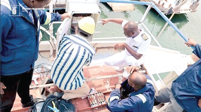 Officials of the Danish Geodata Agency installing the technology on the vessel at the Akosombo Port