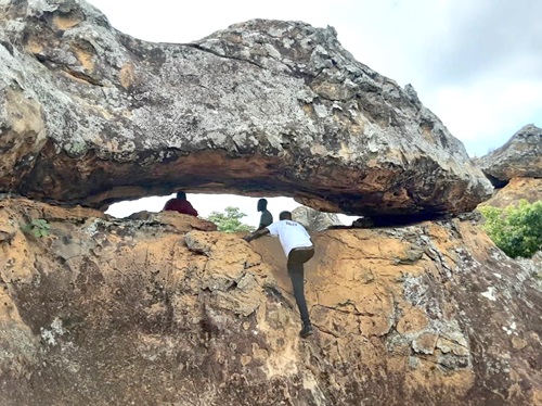 A tourist climbing the rock