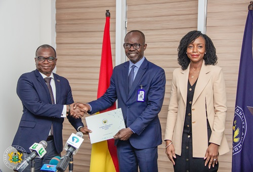 Seun Layade, Head of Project Management &amp; Corporate Development and Acting Head of Technical and Professional Services at CWG Ghana, left, receiving the certificate or license from Dr. Albert Antwi-Boasiako, Director General of the Cyber Security Authority (CSA). Looking on is Adelaide Benneh-Prempeh, a board member of the CSA