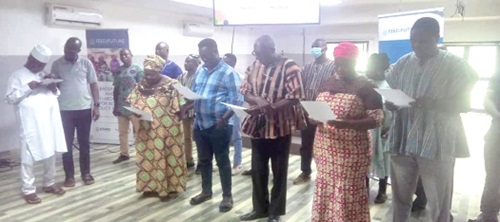Alhaji Abubakari Inusah (left), Chief Director, Upper East Regional Coordinating Council, swearing in the members of RAICU