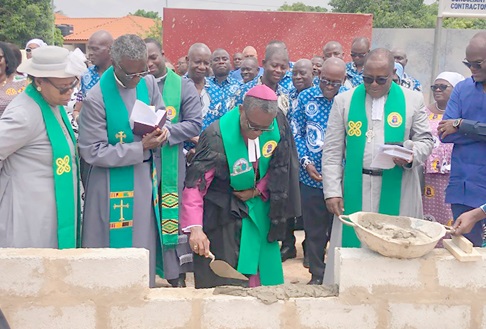 Rt Rev. Edusa-Eyison (middle), Bishop of the Northern Accra Diocese of the Methodist Church Ghana, laying the foundation stone