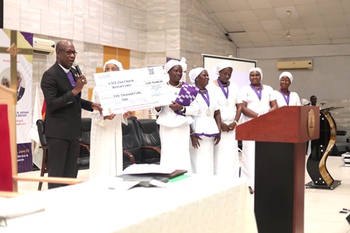 Cynthia Serwaa Dogbe (5th from right), Missionary Supervisor of the Western West Africa Episcopal District of the AME Zion Church, presenting the dummy cheque to Rt Rev. Dr Hilliard Dogbe, Presiding Bishop of the African Methodist Episcopal Zion Church