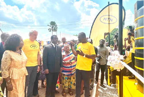 Stephen Blewett (2nd from left), CEO of MTN Ghana, with Rev. John Ntim Fordjour (3rd from left), Deputy Minister of Education, and Joyce Appiah (left), Headmistress of Aburi Presbyterian Senior High Technical School about to comission the water system