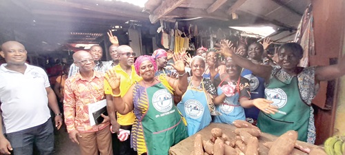 Bright Worlanyo Neku (arrowed), Eastern Regional Director of Ghana Statistical Service, with some traders in the aprons